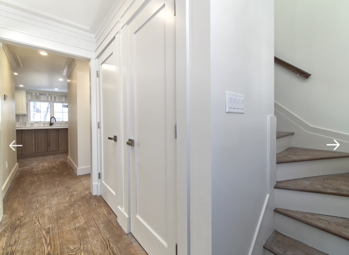 Entry hallway with crown molding and hardwood floors